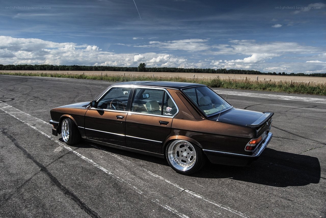 Brown BMW sedan on track