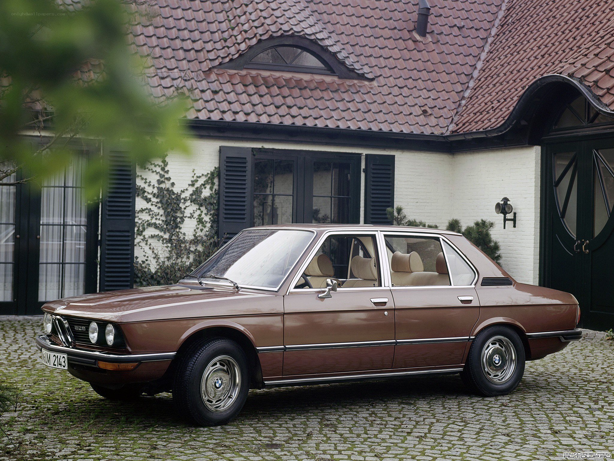 Brown BMW sedan parked outside