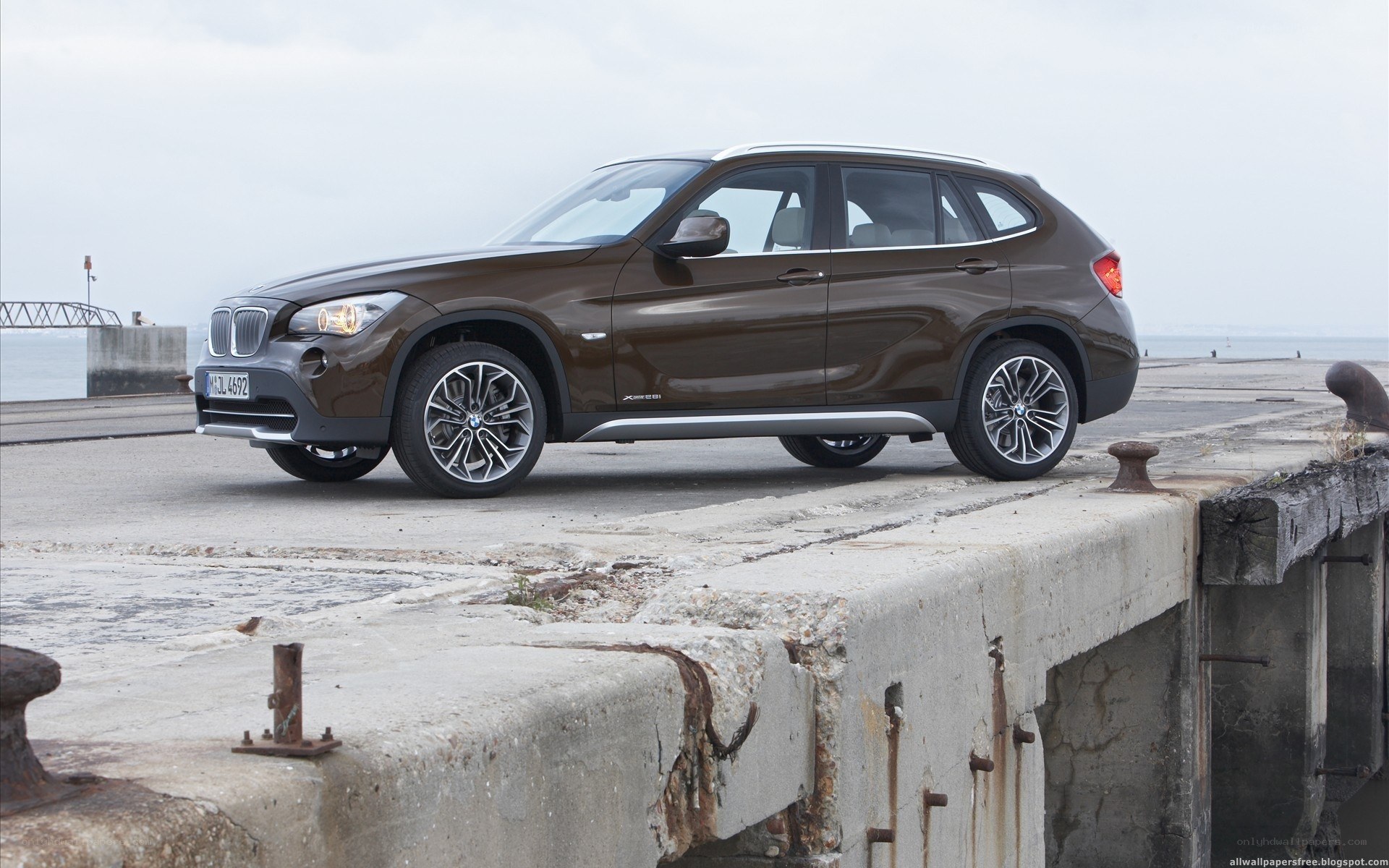 Brown BMW X1 on a pier