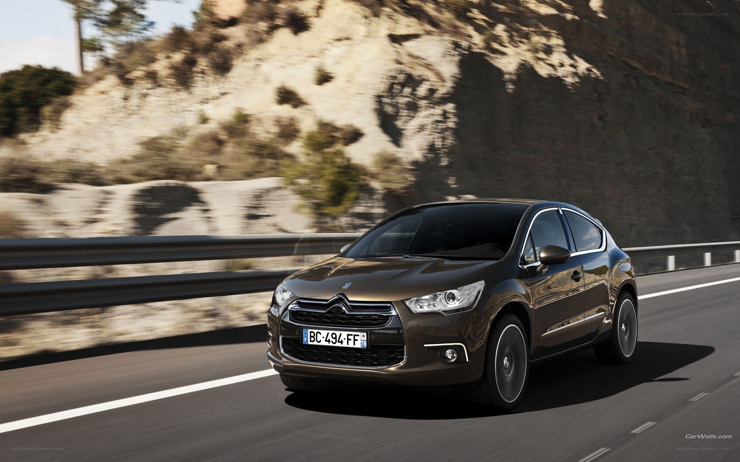 brown citroen c4 driving on road