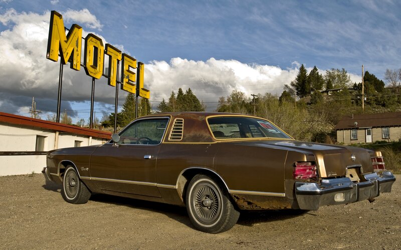 Brown classic car at a motel