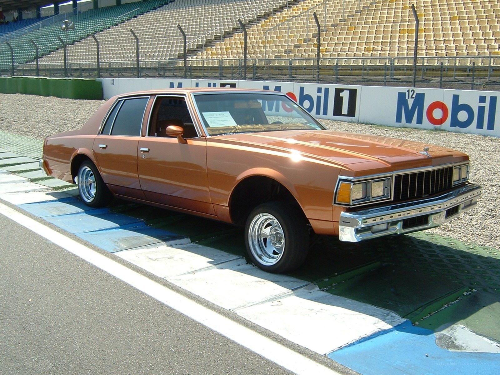 Brown classic car on racetrack