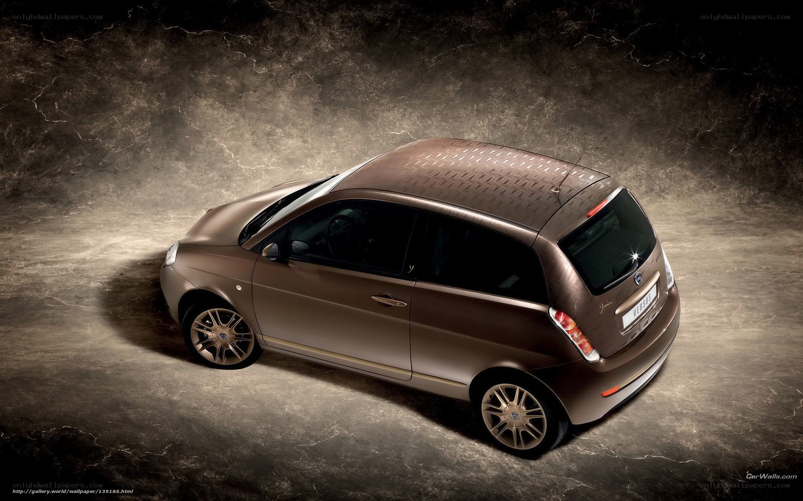 brown compact car on textured background