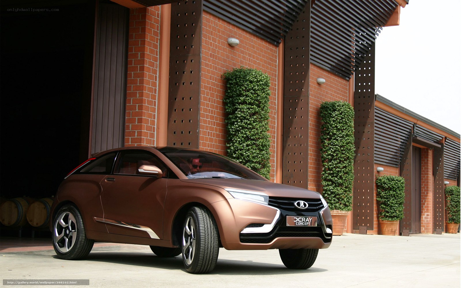 Brown concept car in front of building