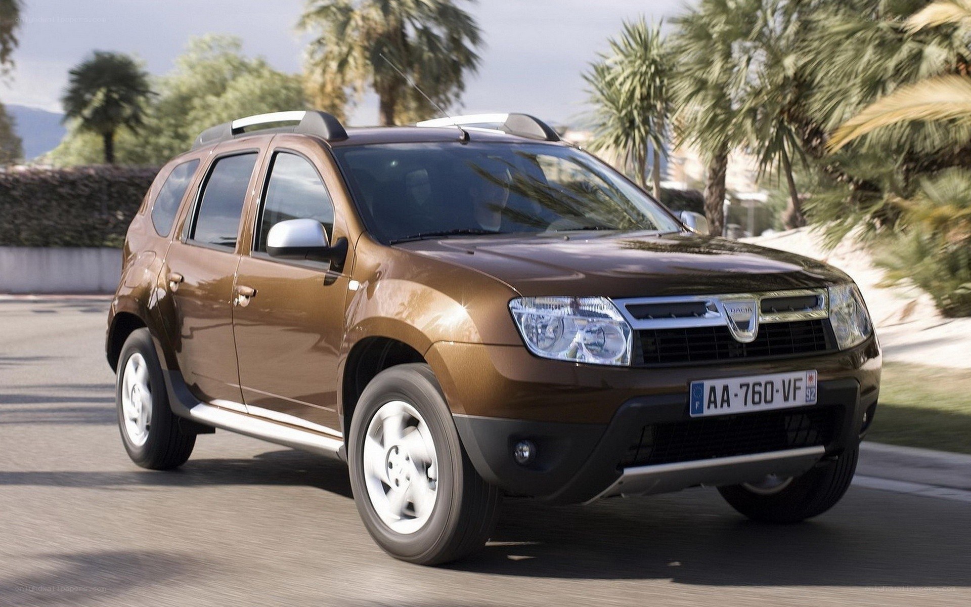 Brown Dacia Duster driving on road