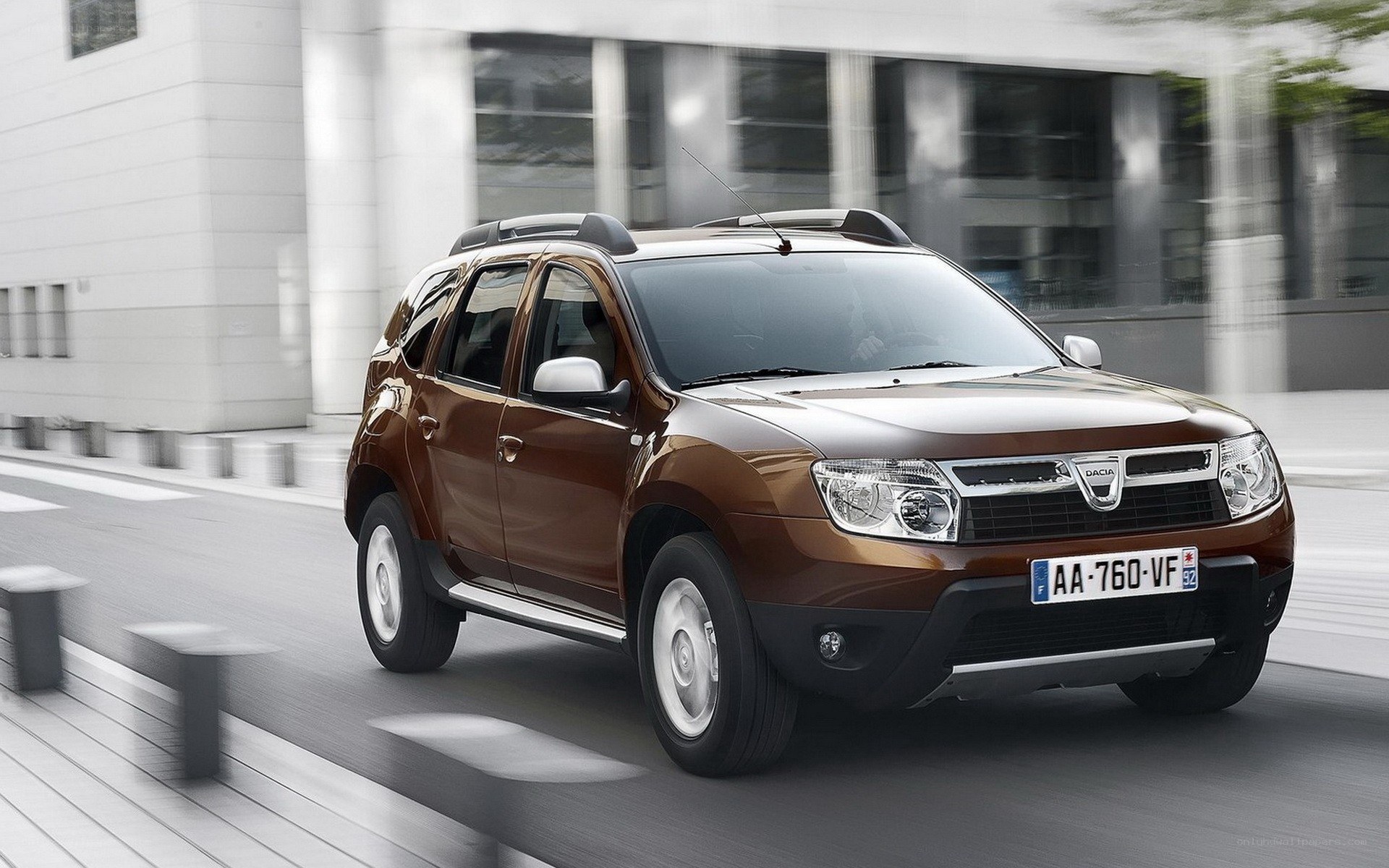 Brown Dacia SUV in motion