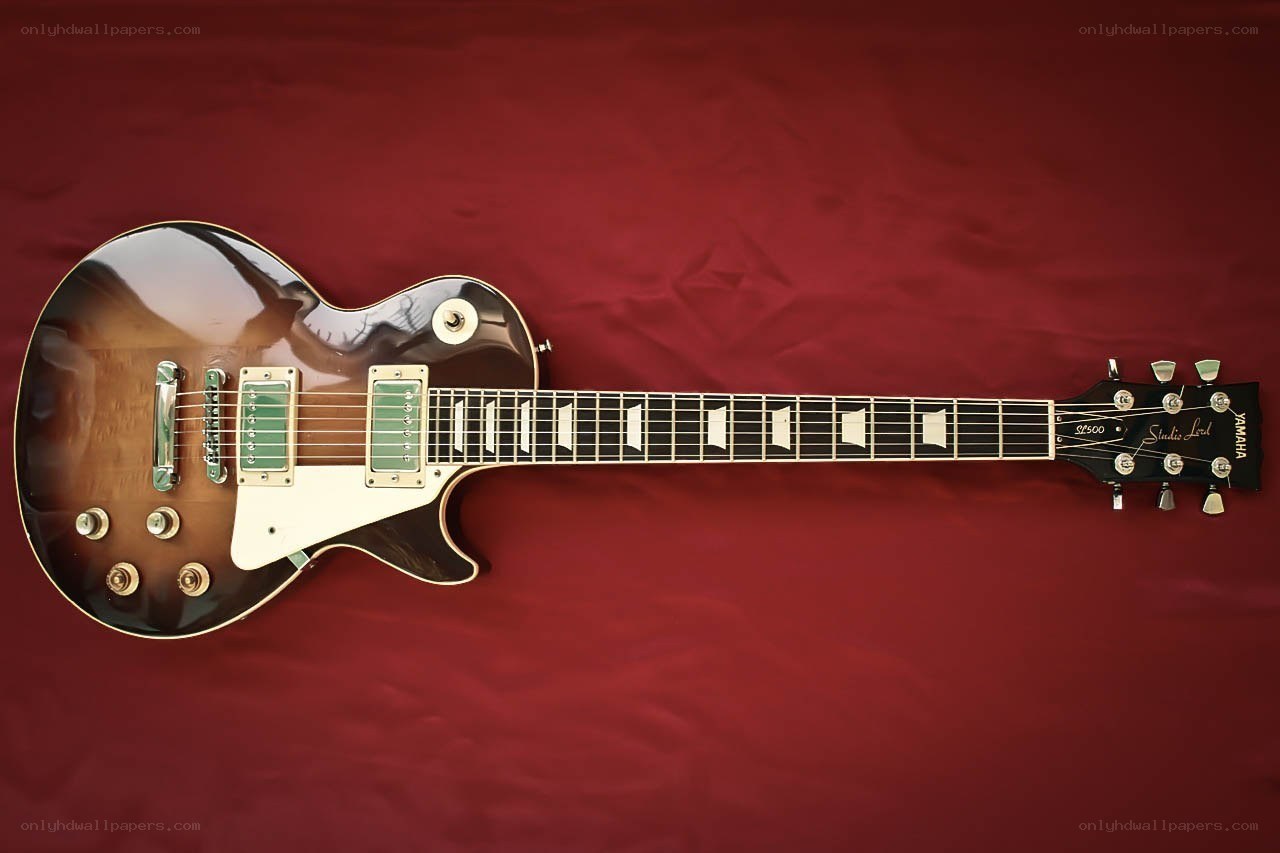 brown electric guitar on red