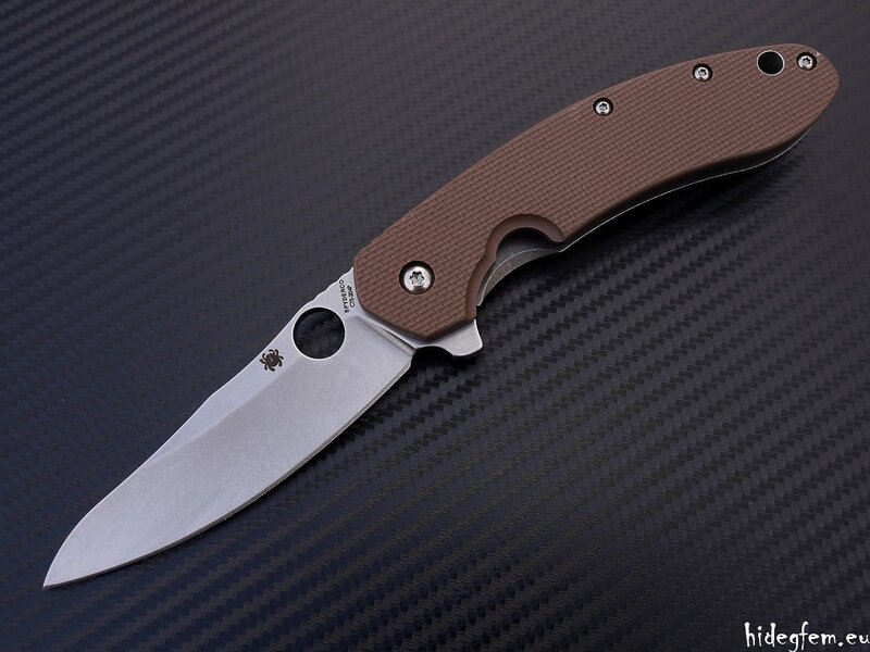 brown folding knife on carbon fiber