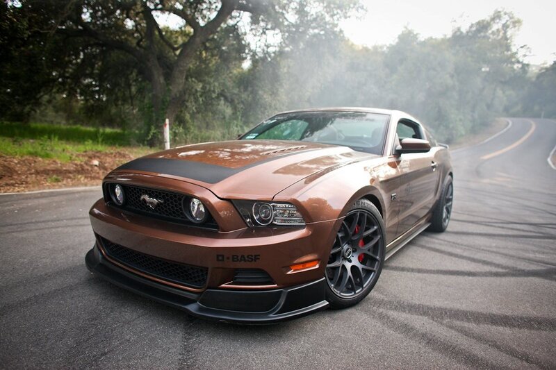 Brown Ford Mustang on a winding road