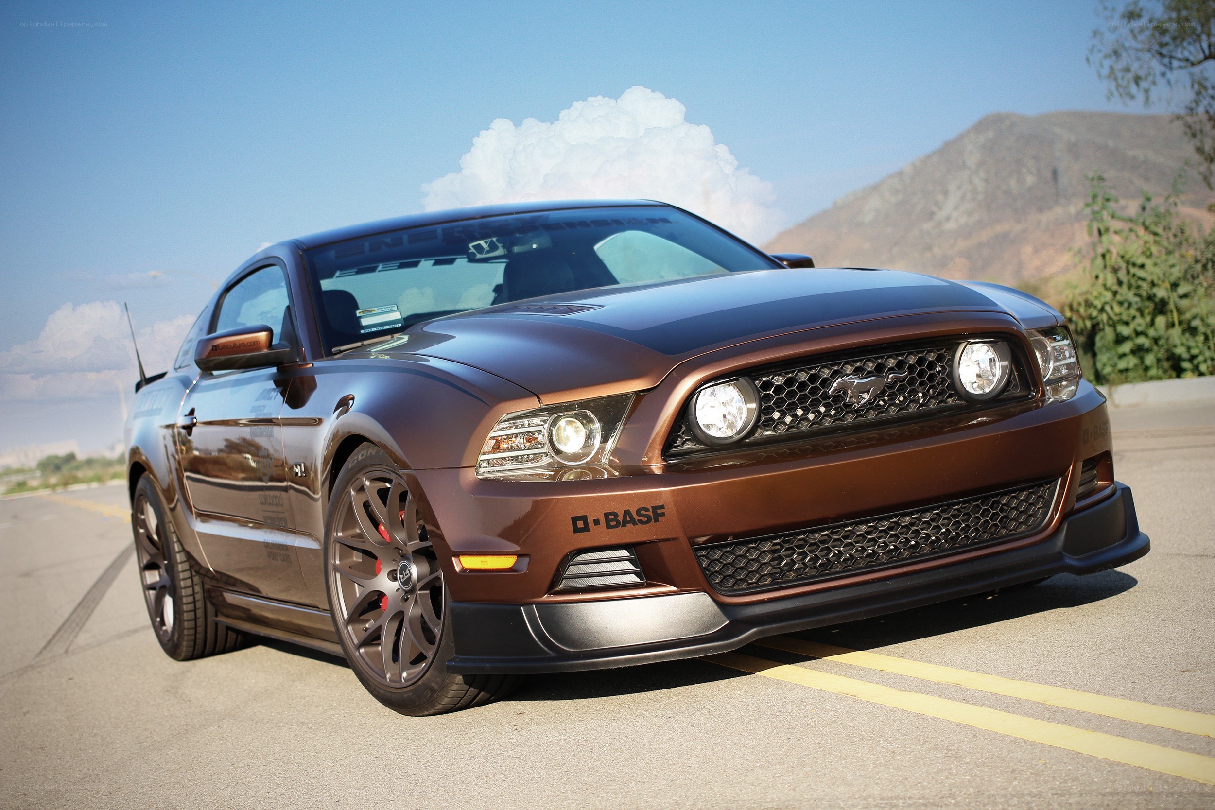 Brown Ford Mustang on road