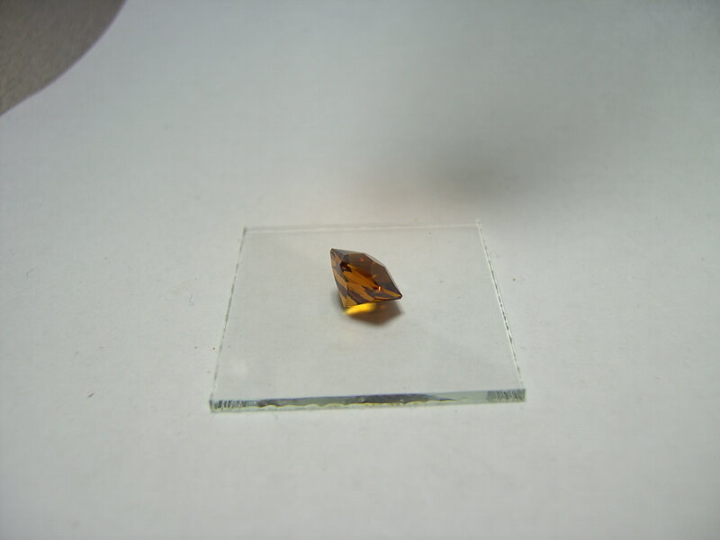 brown gemstone on glass