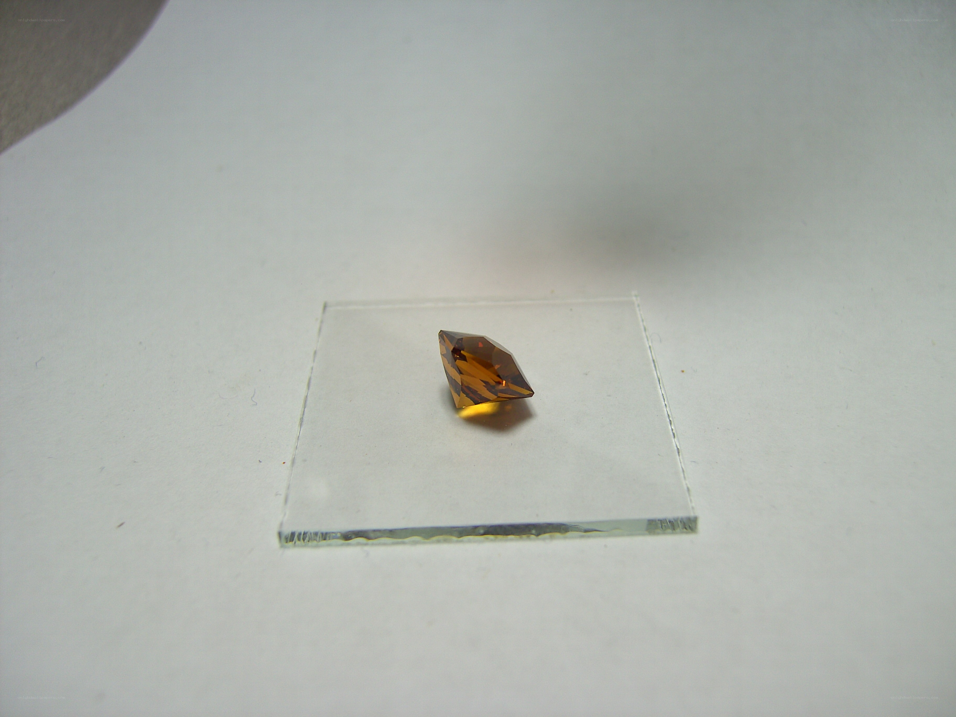 brown gemstone on glass