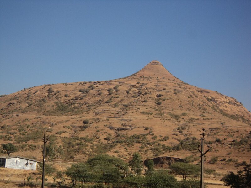 brown hill under blue sky