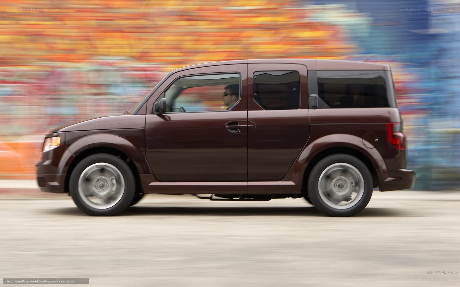 Brown Honda Element in motion