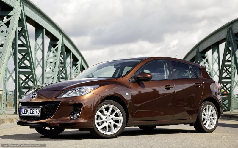 Brown Mazda 3 hatchback on bridge