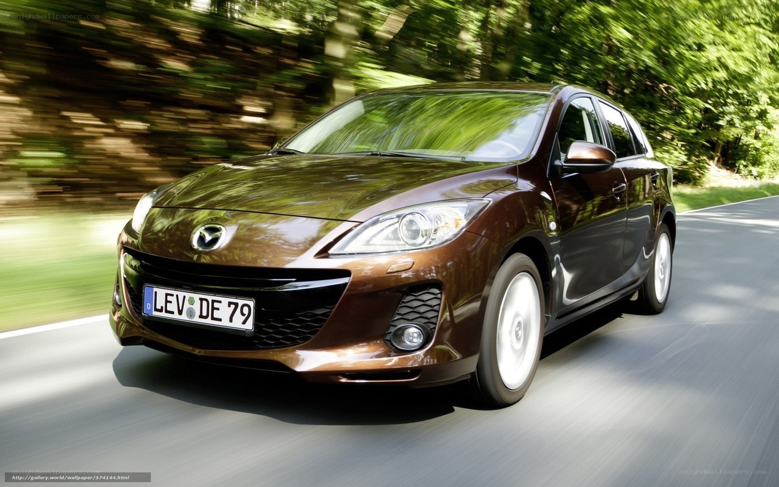 Brown Mazda 3 in motion