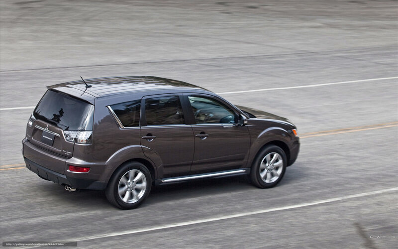 brown mitsubishi outlander in motion