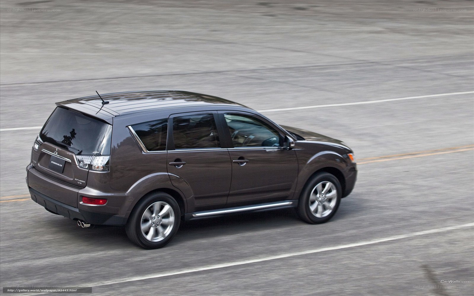 brown mitsubishi outlander in motion