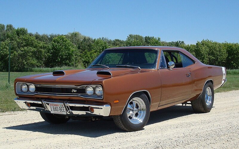 Brown muscle car on gravel