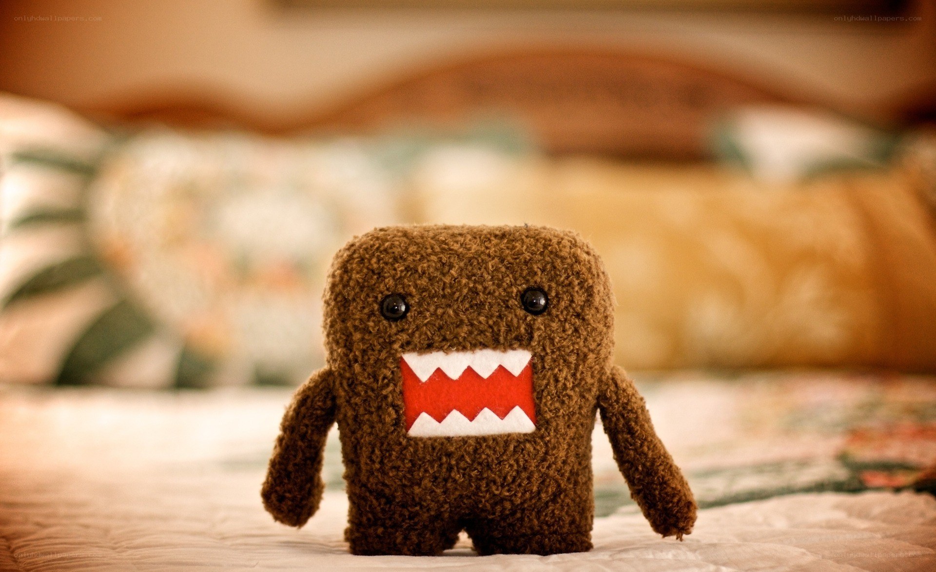 brown plush toy on bed
