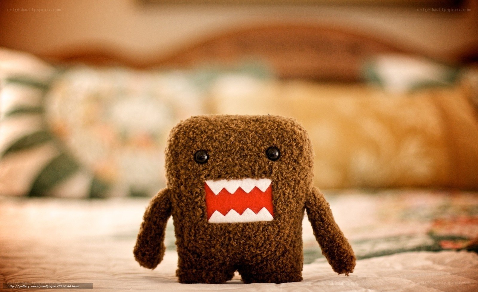 brown plush toy on bed