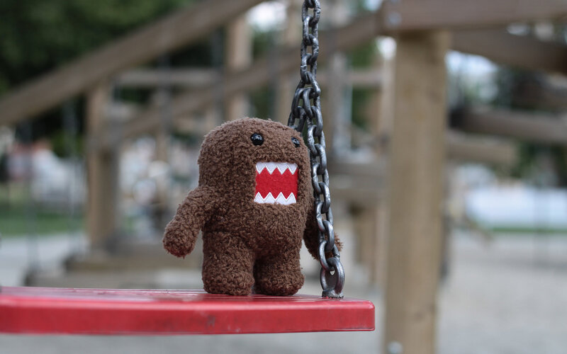 Brown Plush Toy on Swing