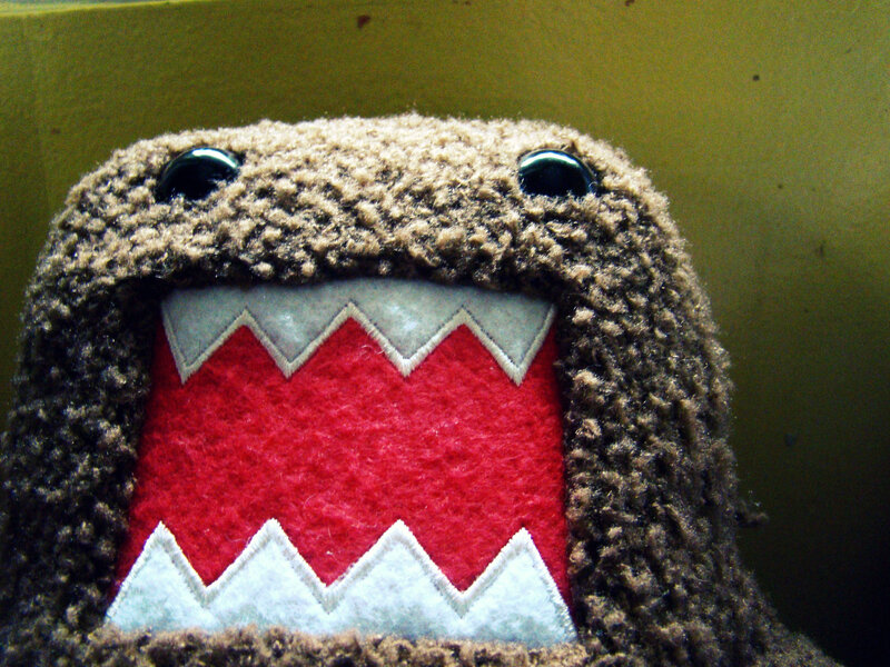 brown plush toy with red mouth