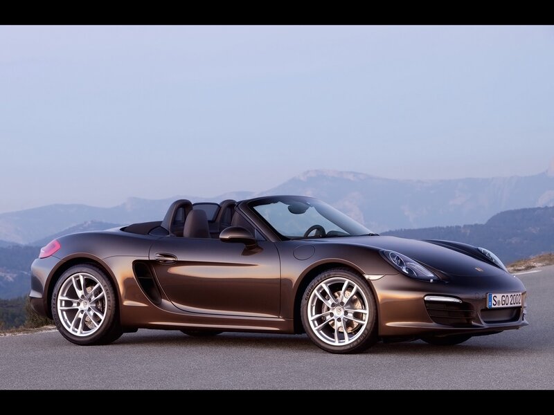 Brown Porsche Boxster on mountain road