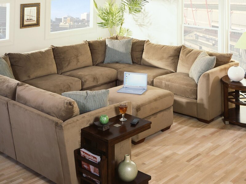 Brown sectional sofa with laptop
