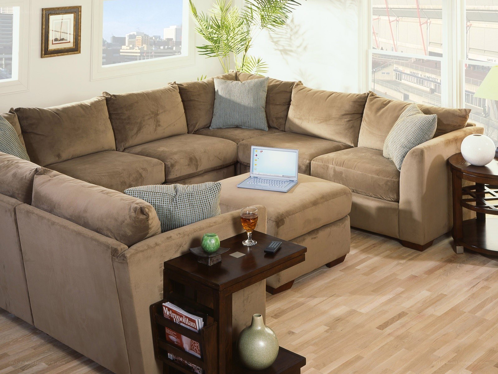 Brown sectional sofa with laptop