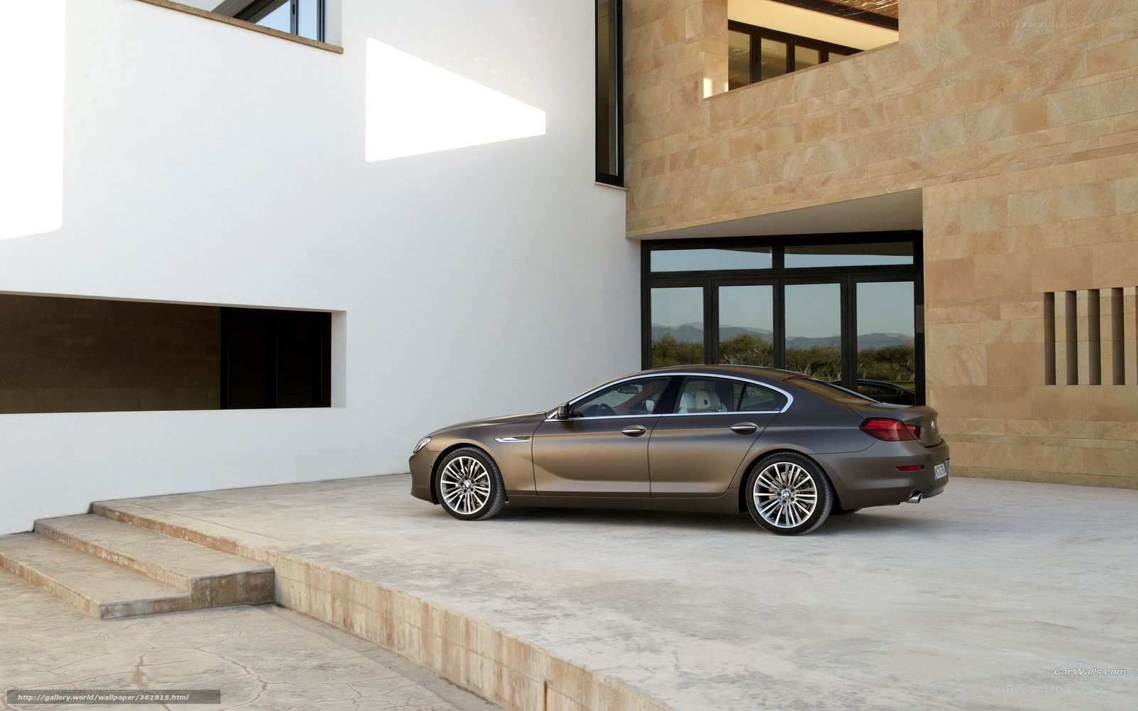 Brown sedan in modern courtyard