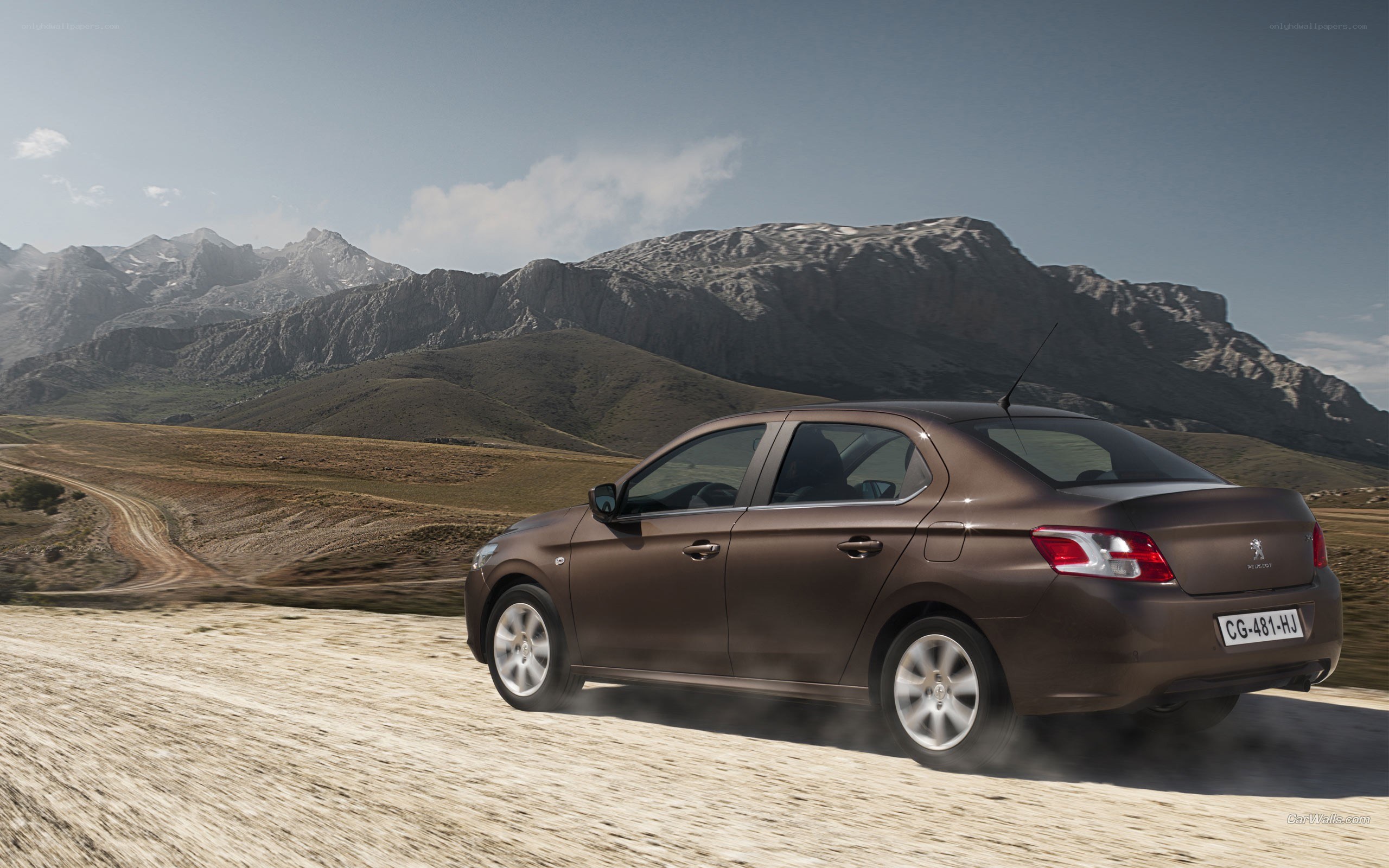 Brown sedan on dirt road