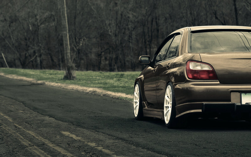 Brown Sedan on Road — Dramatic