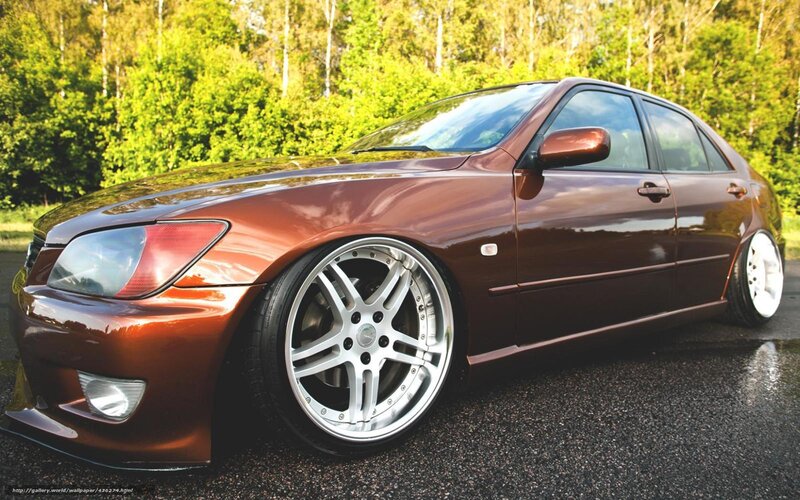 brown sedan with custom wheels