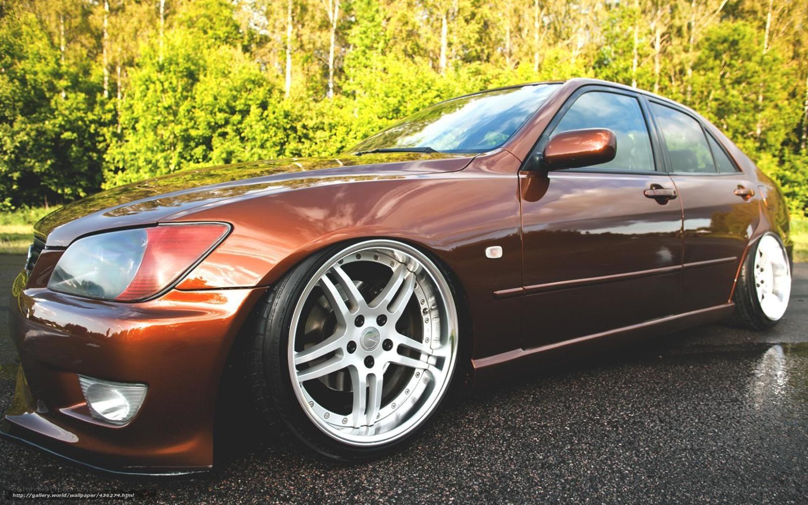 brown sedan with custom wheels