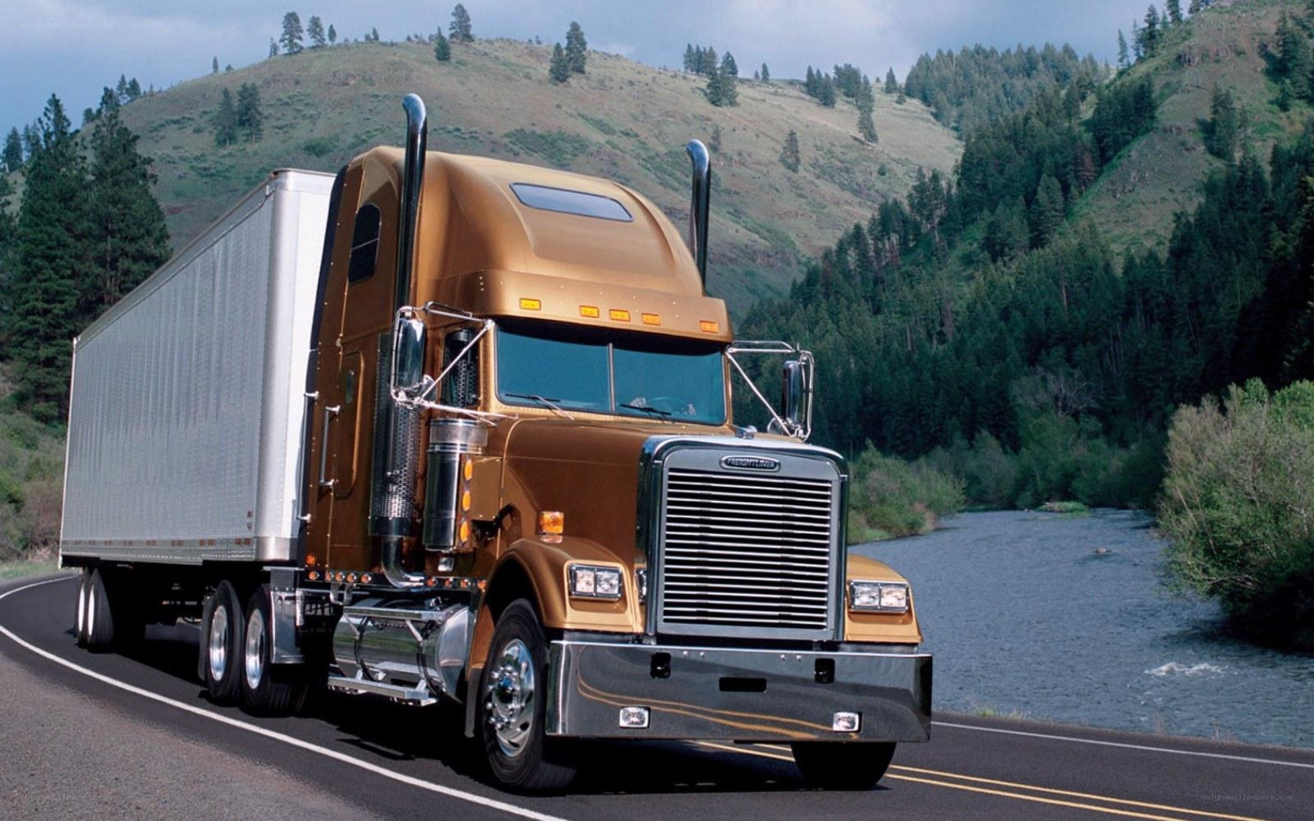 brown semi-truck on mountain road