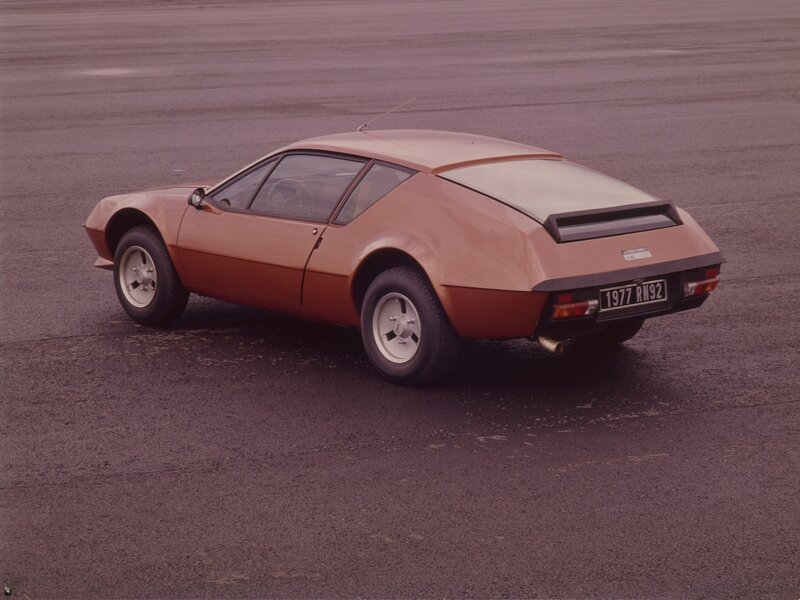 Brown sports car on pavement