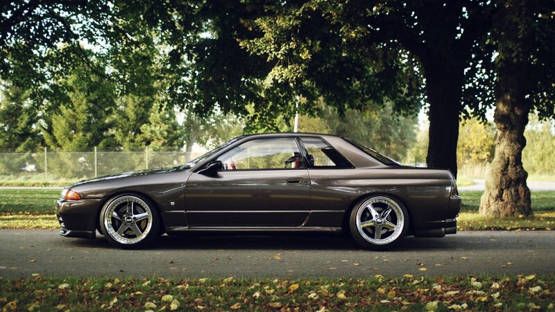 brown sports car under trees