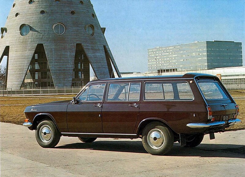 Brown station wagon in front of a unique building