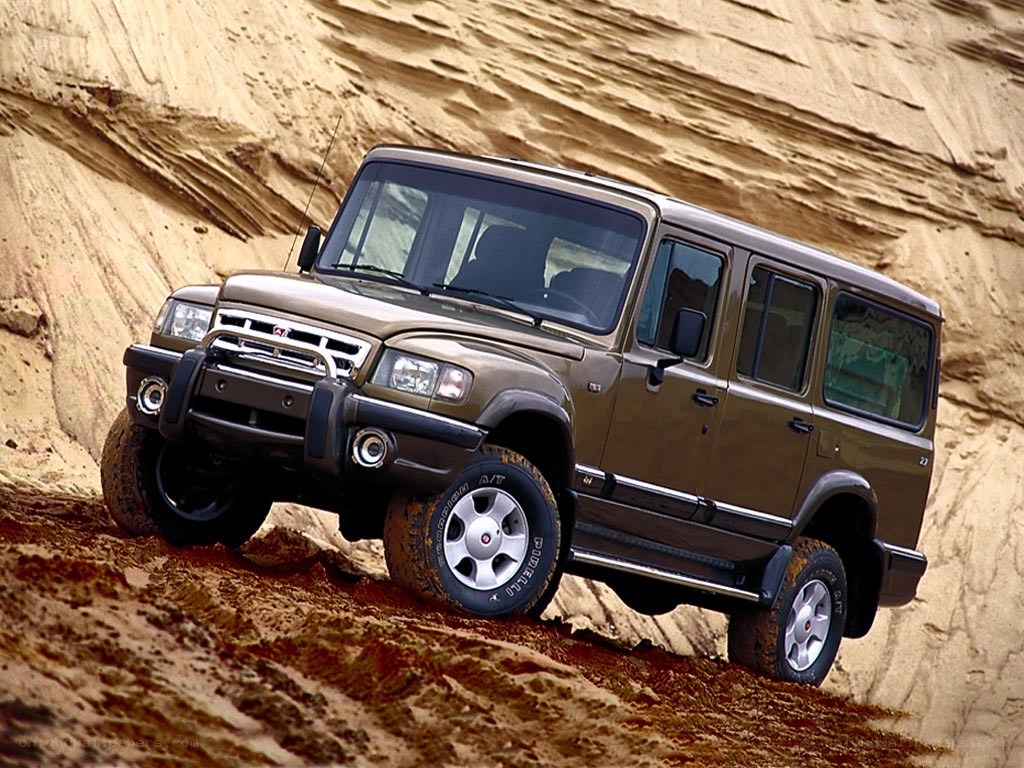 brown SUV on sandy terrain