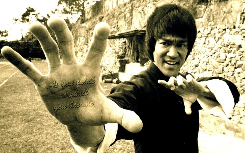 Bruce Lee with quote on hand