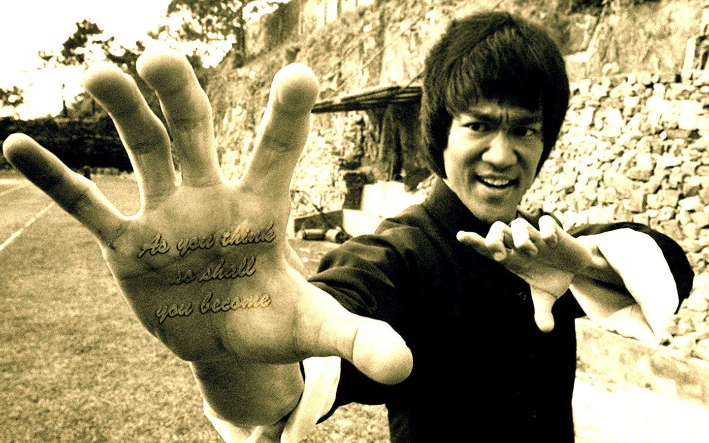 Bruce Lee with quote on hand
