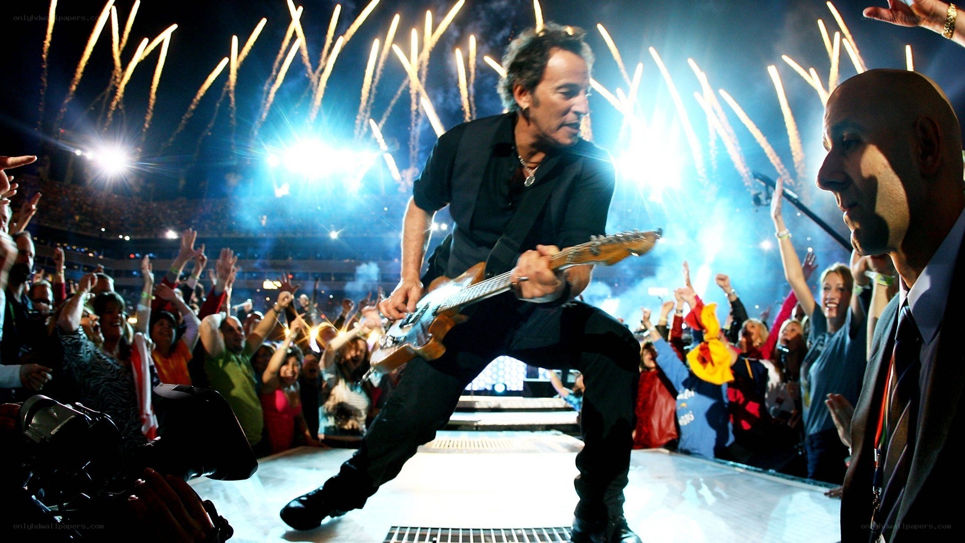 Bruce Springsteen on stage with fireworks