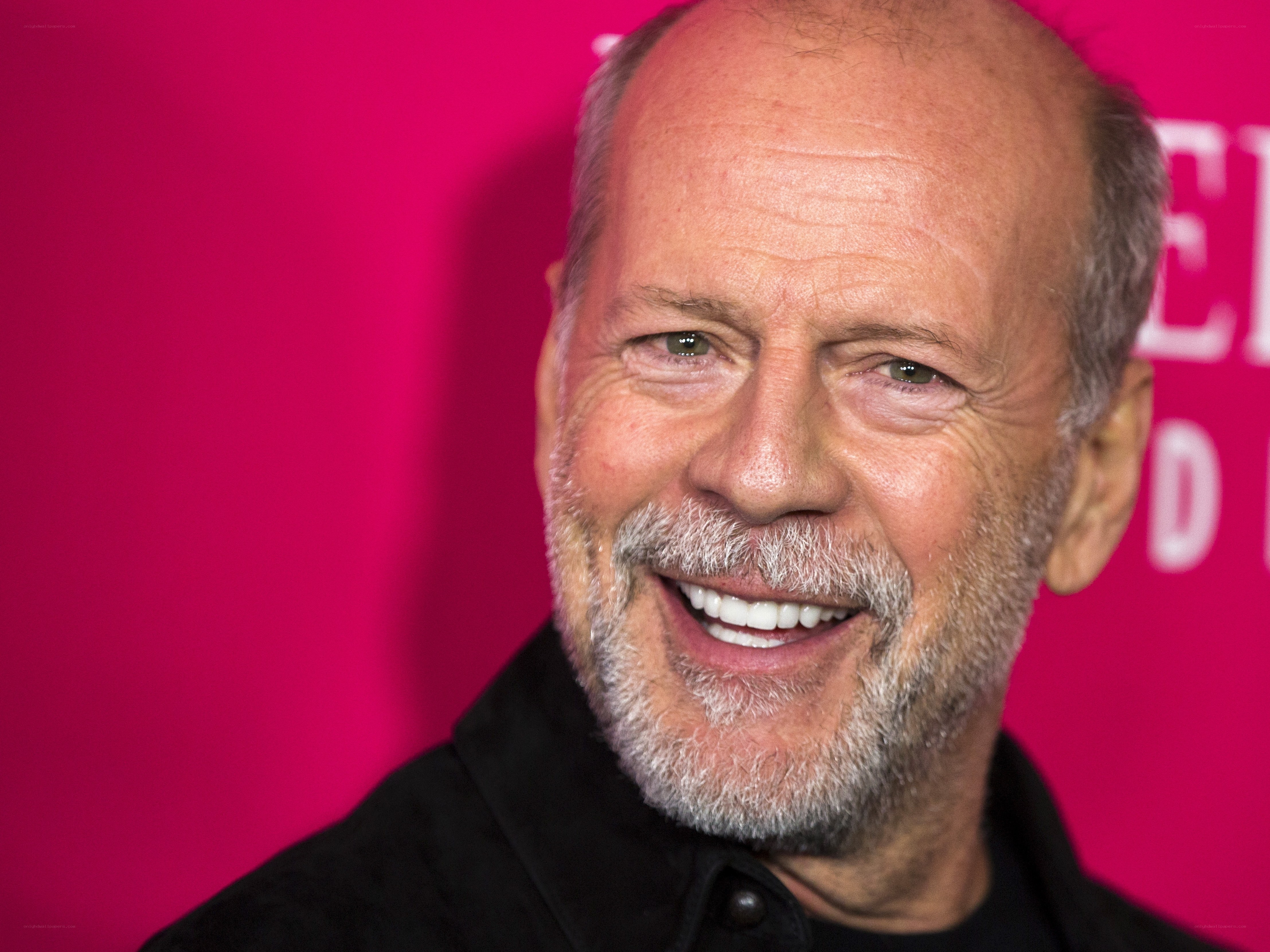 Bruce Willis smiling at event
