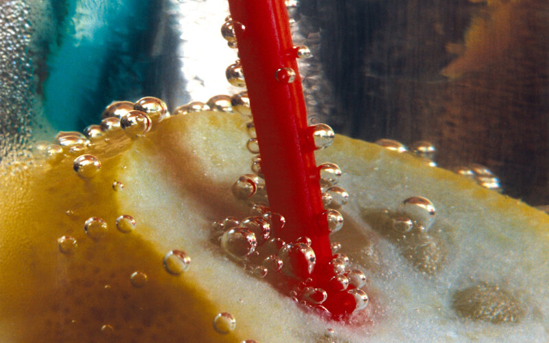 Bubbles around a red straw