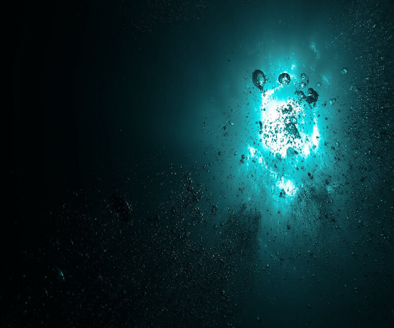bubbles rising in dark water