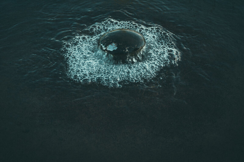 bubbles rising in dark water