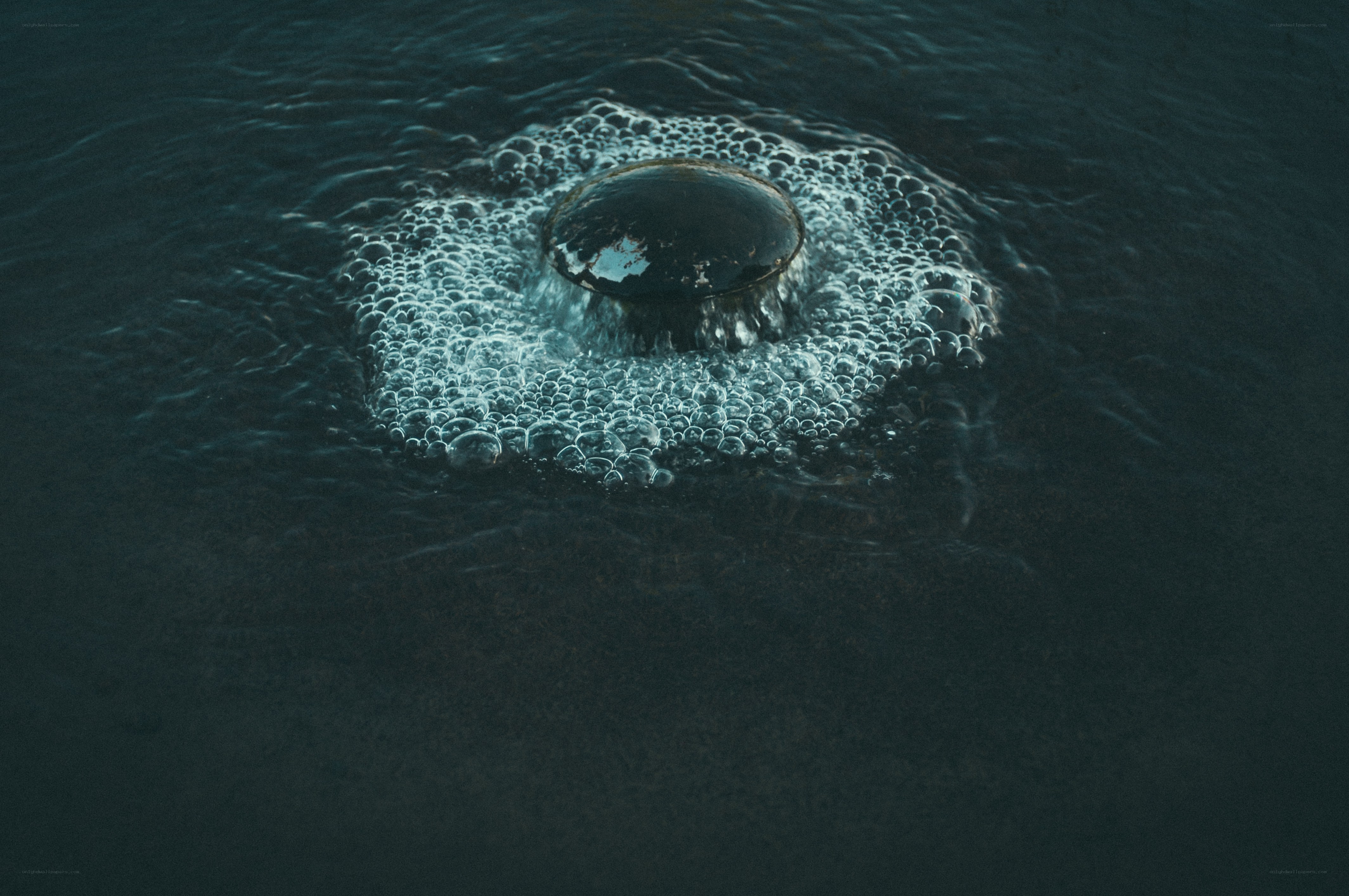 bubbles rising in dark water