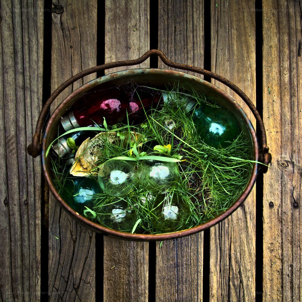 Bucket with glass balls and grass