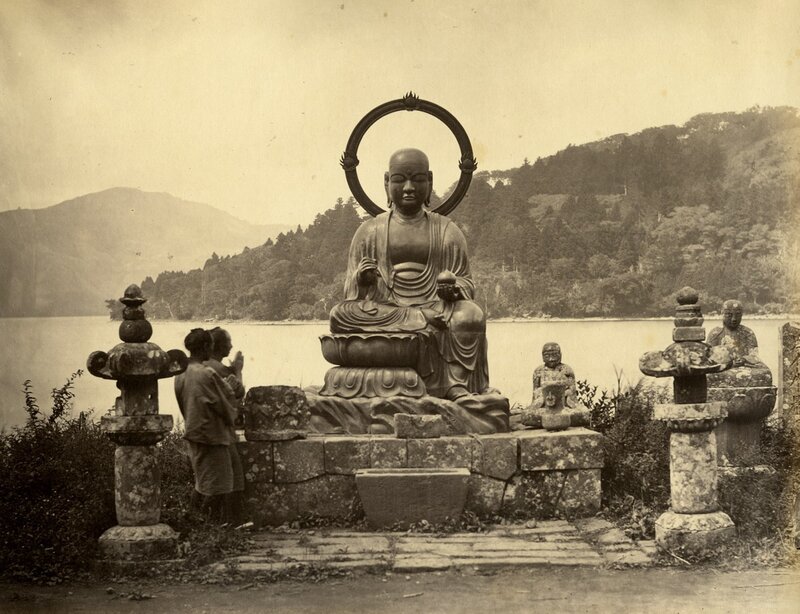 Buddha statue by a lake